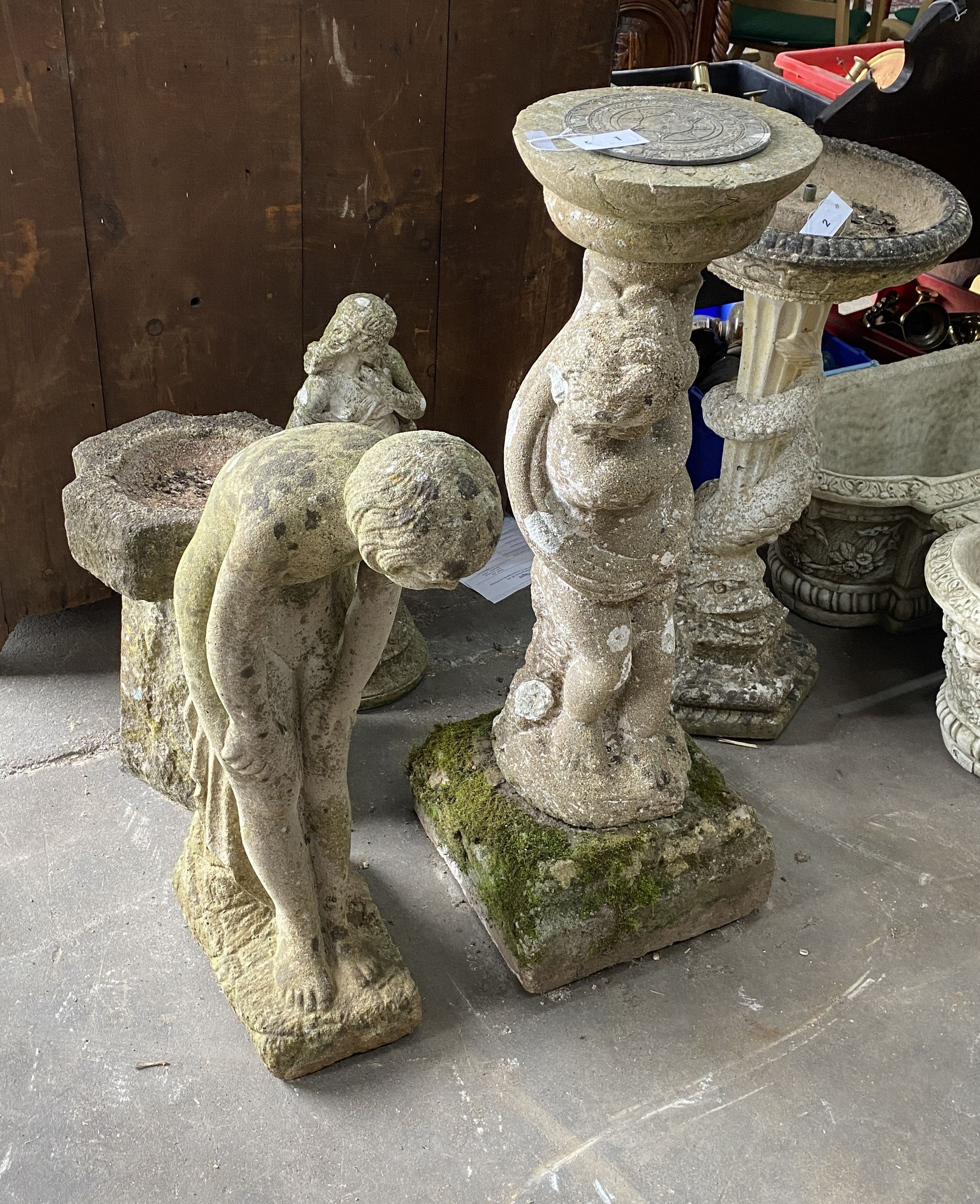 A reconstituted stone figural sundial, a female bather figure, bird bath and one other garden ornament, largest height 98cm